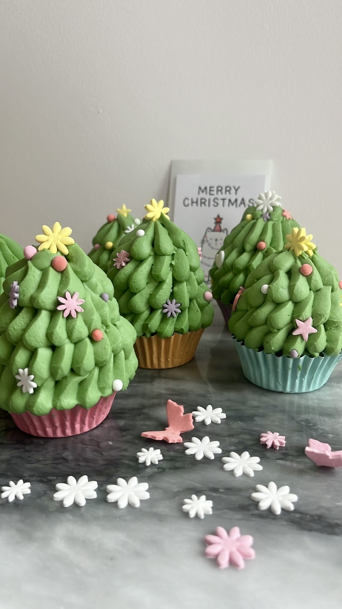 Cupcakes shaped like Christmas tree with matcha cream piped on top, ideal for Christmas celebrations